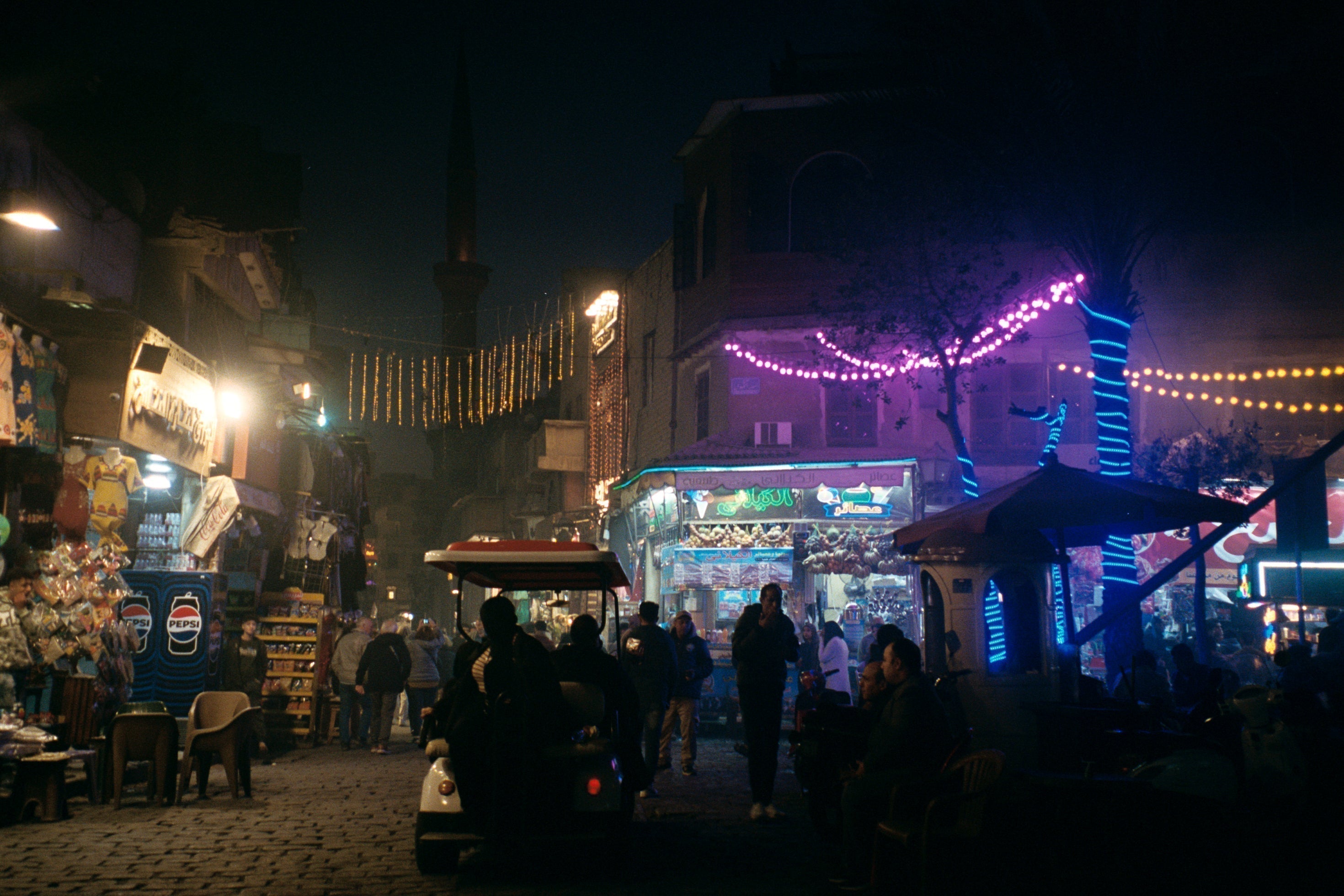 Cairo street lit up with colorful Ramadan garlands and neon lights at night, Egypt — Loud Etudes